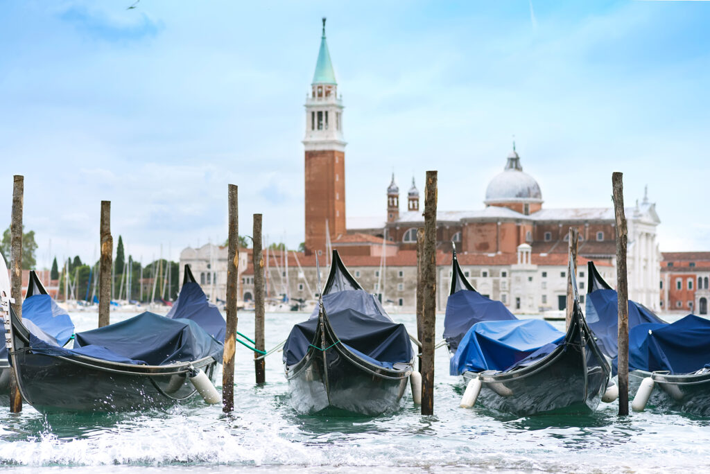 Gondolas moored by Saint Mark square with San Giorgio di Maggiore church in Venice, Italy,