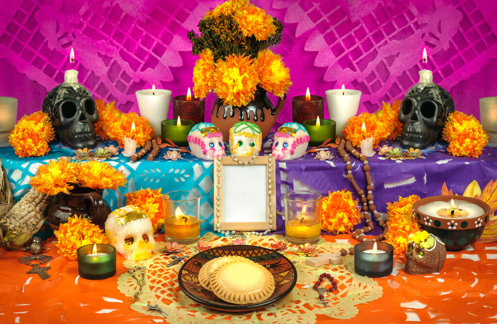 Traditional mexican Day of the dead altar with sugar skulls and candles