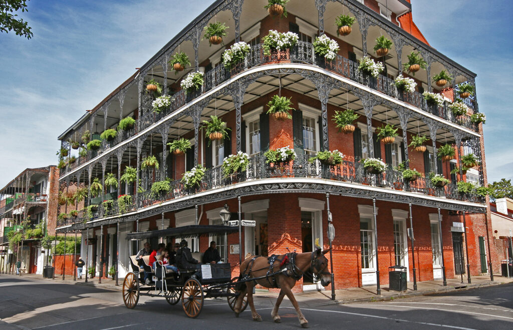 french quarter carriage in front of historic building new orleans, louisiana