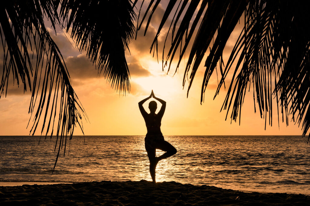 Silhouette of a Woman in Yoga Pose at Sunset