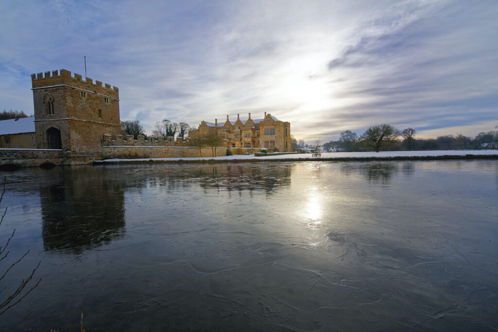 Broughton Castle on an icy lake