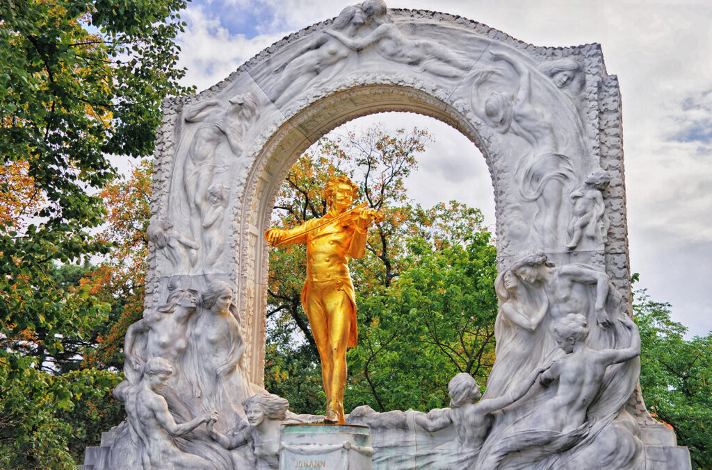 Johann Strauss monument in Stadtpark, Vienna, Austria. Golden statue of great Austrian composer, Waltz King, playing violin