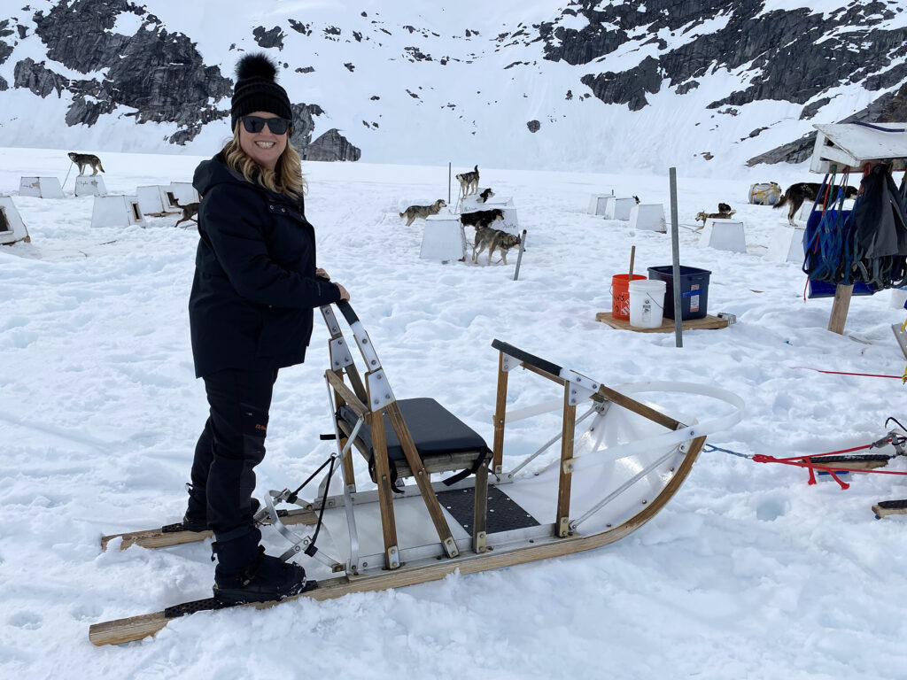 Lady dog sledding in Alaska