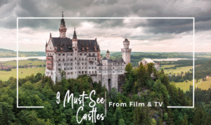 Beautiful Neuschwanstein Castle high on a hill with a cloudy sky